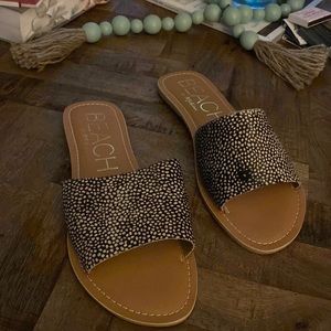 Black and white slip on sandals, size 10.